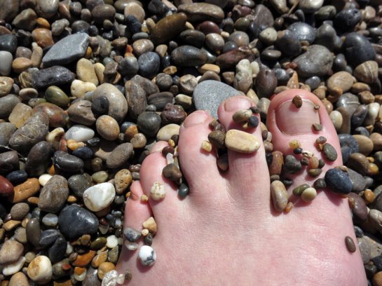 Sara's foot on pebble beach